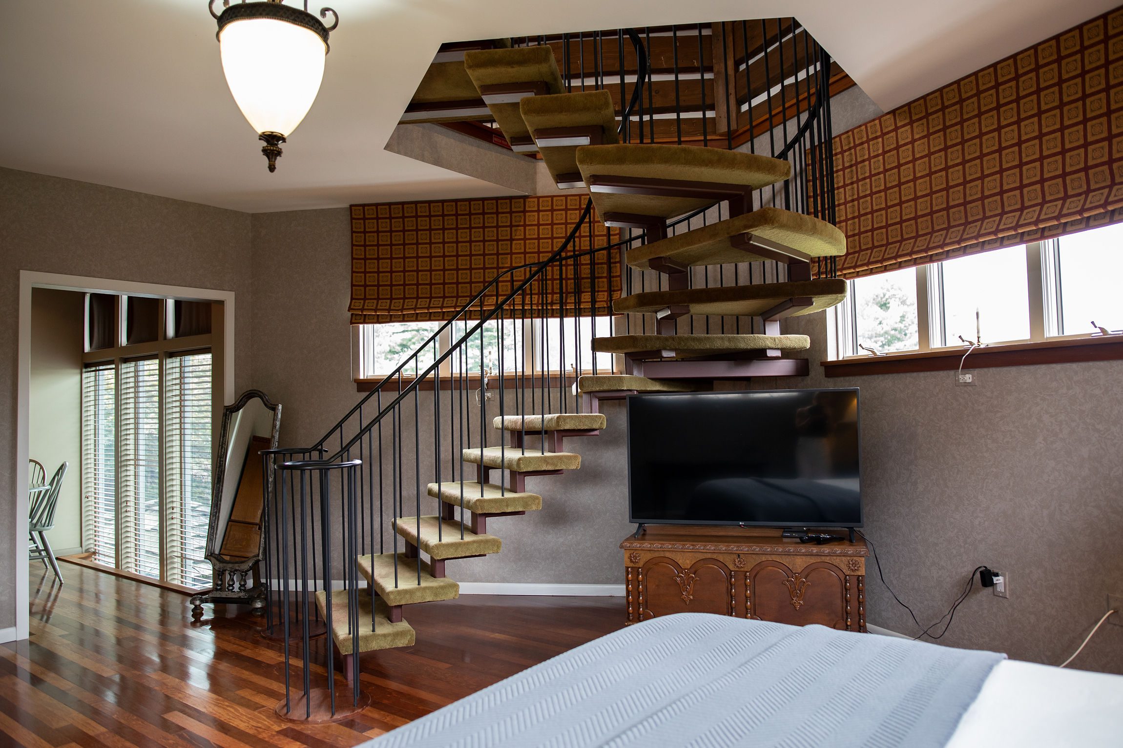 A side view of the Tower Suite's spiraling steps leading to the loft, a great place for couples to relax in Lancaster, PA.