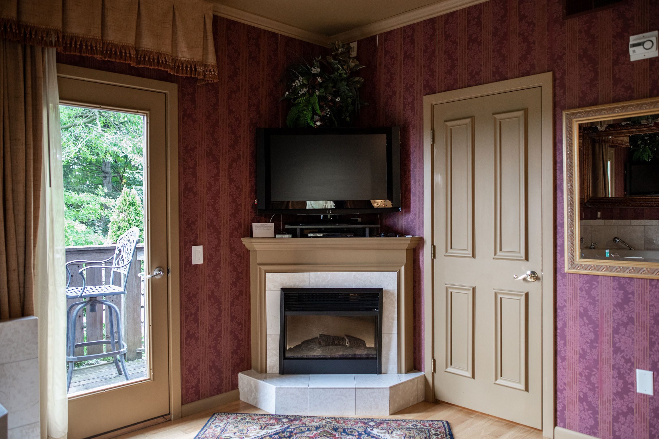 View of the TV and fireplace in the Victorian Suite at Twine Pine Manor in Lancaster, PA